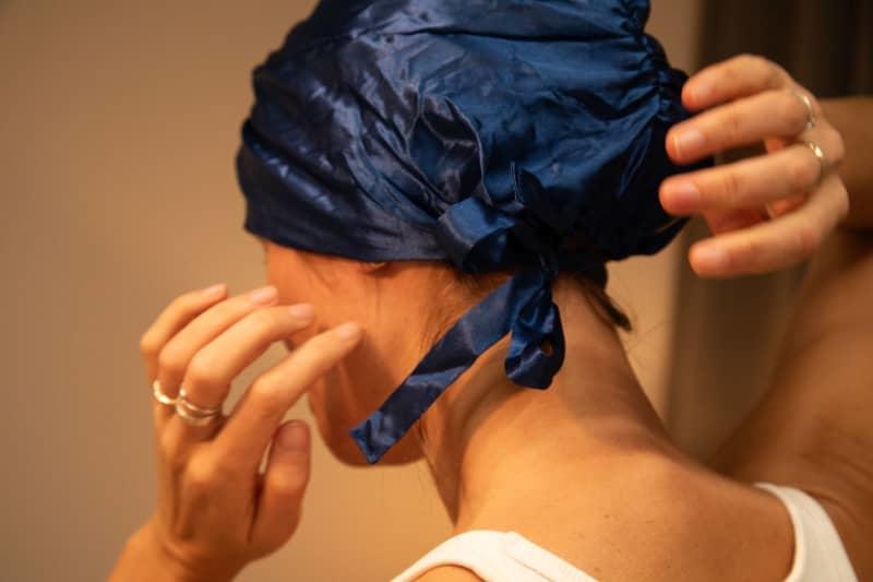 Wearing a silk sleeping cap to prevent frizzy hair
