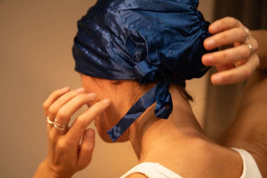 Wearing a silk sleeping cap to prevent frizzy hair